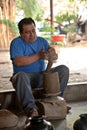 A mexican potter working on a vase in San Bartolo Coyotepec